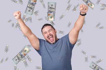 A man celebrating winning a large amount of money. A shower of hundred dollar bills. A lottery or...