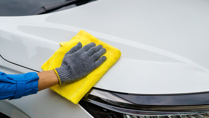 Man cleaning the car with a clean cloth, washing the car, wiping the car, polishing the car, wiping...