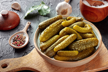 Pickled cucumbers with salt, pepper, garlic, and bay leaf. Fermented food. Homemade canned gherkins...