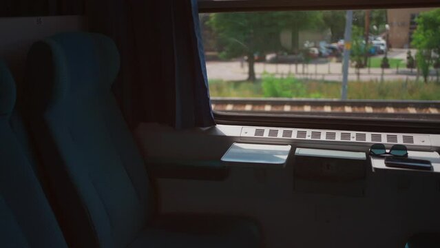 train window and chair, speed railway, green trees outside
