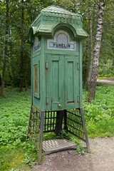 Vintage wooden green telephone (puhelin) booth, Seurasaari Open-Air Museum, Helsinki, Finland.