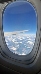 Beautiful view from above to the ground from the window of an airplane flying above the clouds. Shadows from clouds on the Earth's surface