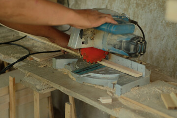 carpenter measuring, cutting, sanding wooden in workshop