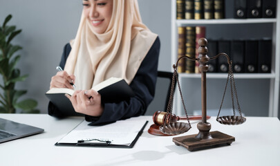 Muslim lawyer businesswoman working or reading law book in office workplace for consultant lawyer...