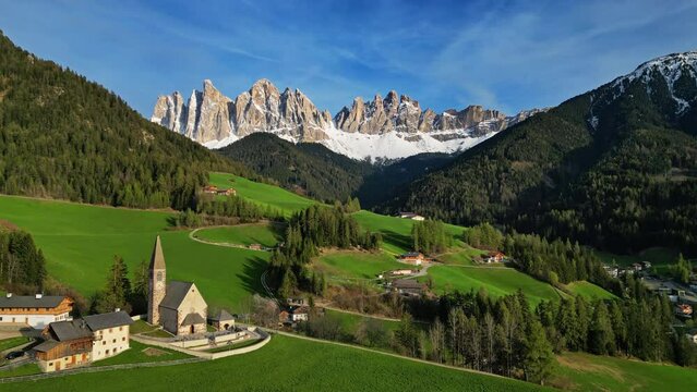 Spring landscape with shurch in Santa Magdalena village, Italian Dolomites Alps, in South Tyrol, Val di Funes, Italy, 4k