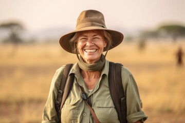 Naklejka na ściany i meble Medium shot portrait photography of a joyful mature woman wearing a classic fedora at the serengeti national park tanzania. With generative AI technology