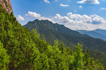 Mala Fatra National Park, view from the peak of Kis-Rozsutec, Maly Rozsutec to the peak of Velky Rozsutec. Mountain landscape with a hiking trail on a summer sunny day.