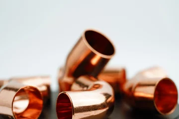 Foto op Plexiglas  Copper pipe plumber fittings elbow connectors socket accessories tubes faucet copper adapter © Mike Maniatis