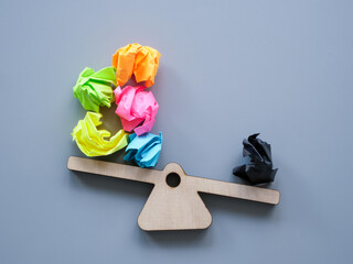 Scales and paper balls as symbol of positive and negative thoughts.