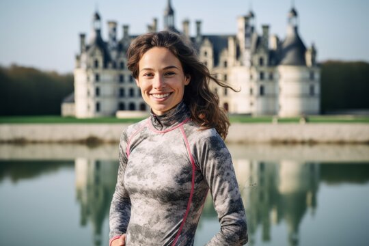 Environmental portrait photography of a joyful girl in her 30s wearing a vibrant rash guard at the chateau de chambord in chambord france. With generative AI technology