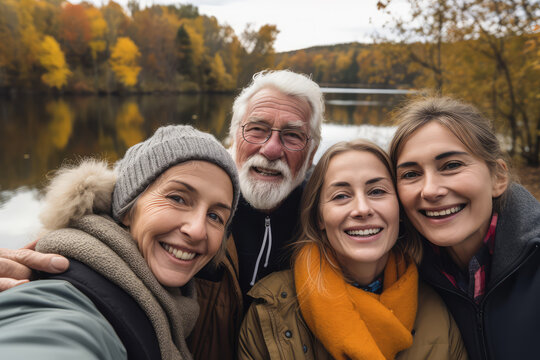 Family senior taking selfie on lake shore