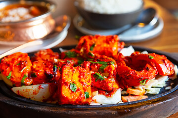 Tandoori Paneer Tikka. Cubes of cottage cheese, tomatoes, bell peppers and onion finished in clay oven.