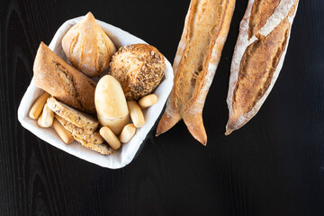 Different types of bread cut into slices and whole