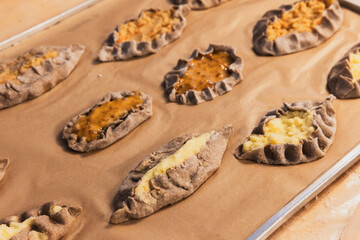 Karelian pasties with mashed potato and carrot filling - obrazy, fototapety, plakaty