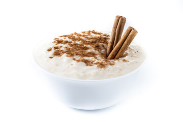 Arroz con leche. Rice pudding with cinnamon in white bowl isoalted on white background