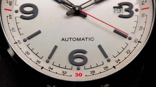 Stylish Luxury Man Wrist Watch With Moving Hand And Multiple Dials. Men's watch in metal with sapphire crystal. Closeup view of rotating watch, running second arrow. Cyclops watch