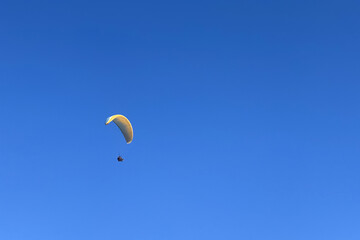 paraglider against the blue sky, shot from below