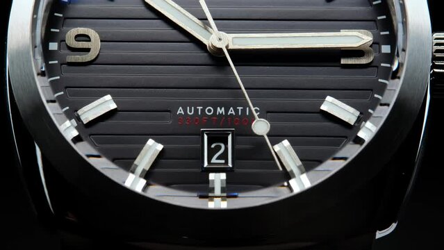 Stylish Luxury Man Wrist Watch With Moving Hand And Multiple Dials. Men's watch in metal with sapphire crystal. Closeup view of rotating watch, running second arrow. Cyclops watch