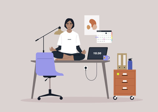 A young manager meditating on their desk in the workplace, using a mindful approach to reduce stress levels