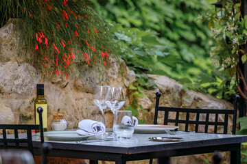 Al fresco table waiting for customers at an outdoor restaurant in the medieval town of Saint Paul...