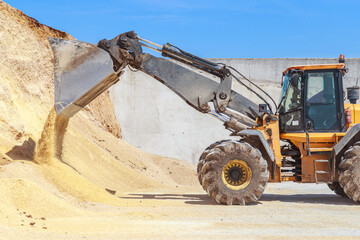 Bulldozer loads food for cows. © Елена Бионышева-Абра