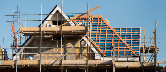 Europe, UK, England, Surrey, scaffolding on house roof renovation