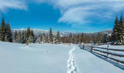 Picturesque winter morning mountain view from alpine path with footprint. Skupova mountain slope,...