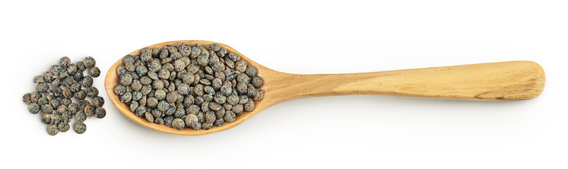 raw french green lentils in wooden spoon isolated on white background. Top view. Flat lay