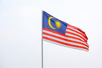 The Malaysia flag also known as Jalur Gemilang waves with a clear sky in the background. Independence Day or Merdeka Day celebration on 31 August and Hari Malaysia on 16 September, copy space concept.