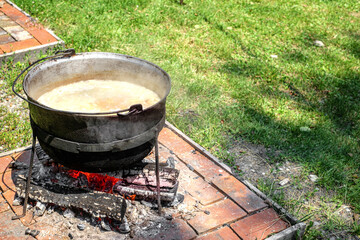Romanian traditional food prepared at the cauldron on the open fire - obrazy, fototapety, plakaty