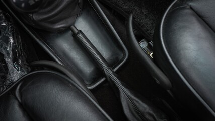 Black handbrake inside a car