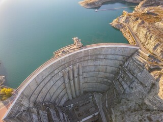 Aerial view of a concrete dam in the mountains.