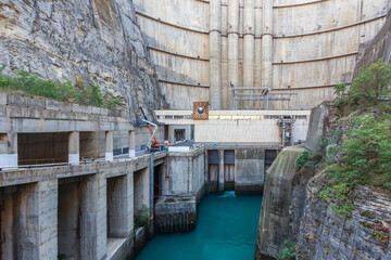 View of the high concrete dam from the bottom.