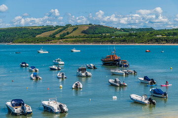 A view from the harbour as the lifeboat launches in at New Quay, Wales in summertime