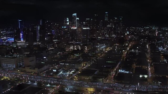 
Lightning Storm Strike over Downtown LA at Night. Aerial View of Los Angeles Skyline. Thunderstorm. Climate Change. Traffic in Highway. Shot from Helicopter in 8K.