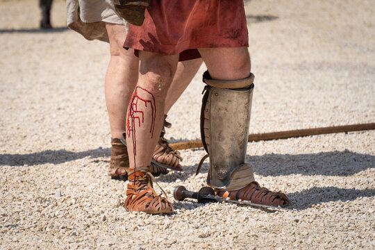 A defeated gladiator with bleeding feet