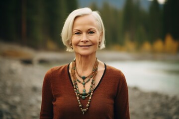 Environmental portrait photography of a satisfied mature woman wearing a stunning statement necklace at the banff national park in alberta canada. With generative AI technology - obrazy, fototapety, plakaty