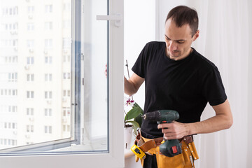 Master in gloves adjusting pvc windows with screwdriver closeup. Installation of plastic windows repair and maintenance concept