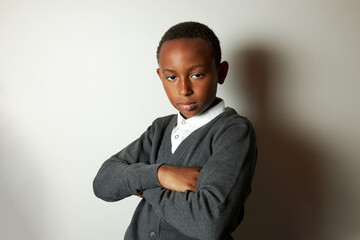 Portrait of offended arrogant stubborn rebellion schoolboy of african american ethnicity standing...