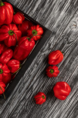 Red habanero peppers on a black table. Top view.