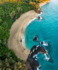 Aerial drone view of the rocks and waves at the end of Lumaha'i beach on north coast of Kauai in...