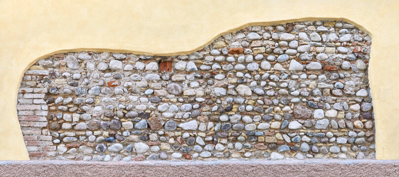 Typical rustic house wall with unplastered wall part, in Tuscany. 