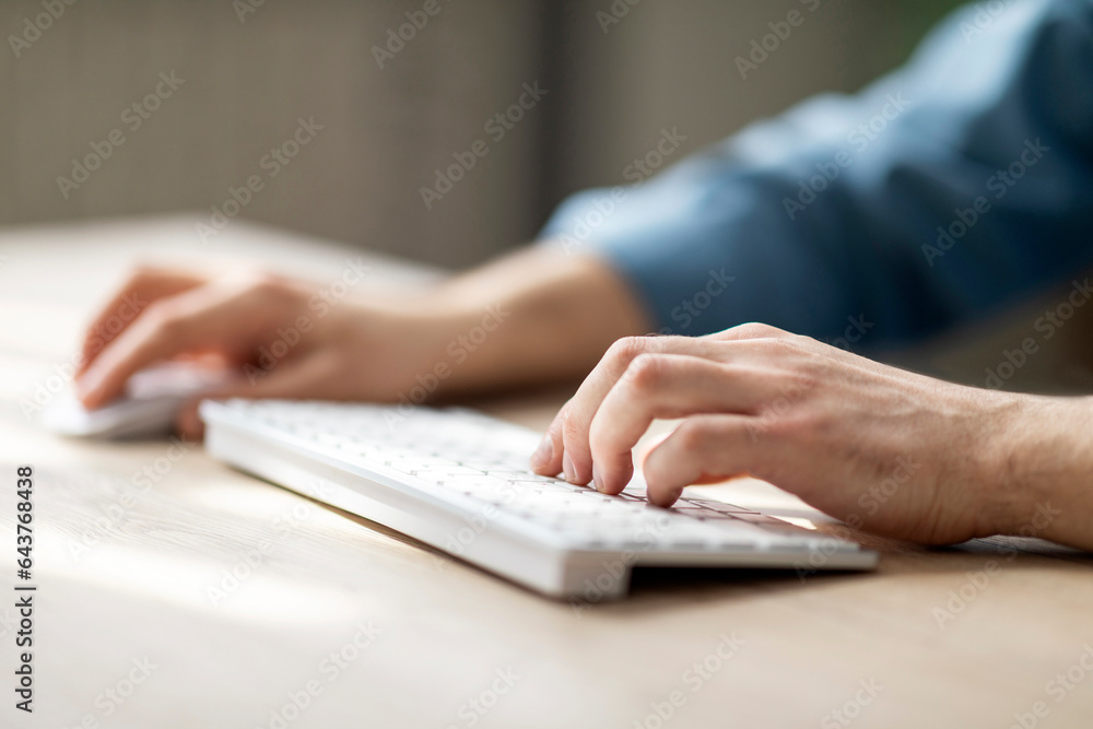 Aufkleber Unrecognizable Man Typing On Computer Keyboard And Using Wireless Mouse