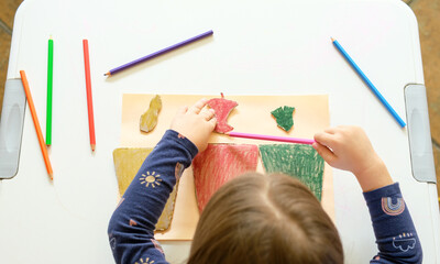 Little girl playing with poster of garbage containers for sorting at kindergarten or primary...