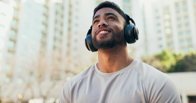 Man, thinking and music with headphones in city for a workout, calm exercise or training. Athlete person outdoor with happy smile for meditation, fitness and listening to audio for motivation on run
