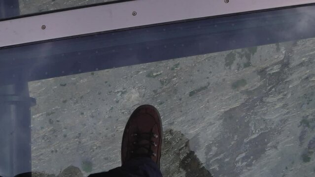 Walking along glass skywalk with views of the valley below Alberta, Canada. Jasper National Park. 