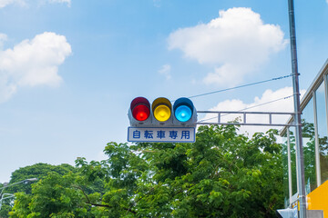 Japanese traffic lights and sign above scramble crossing in front of Tokyo station ,Japanese under...