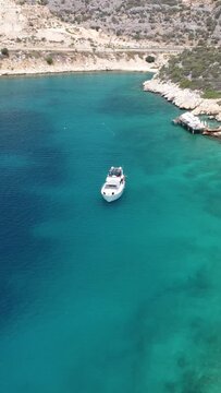 Drone shot of a white yact sailing off the coast of Turkey.