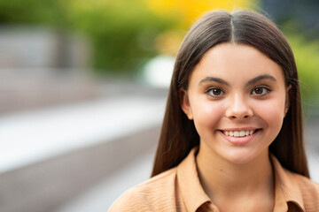 Closeup portrait of pretty young woman posing outdoor