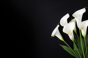 Flaming candles and calla lilies on a dark backdrop, providing ample text space. Conceptual representation of a memorial service.